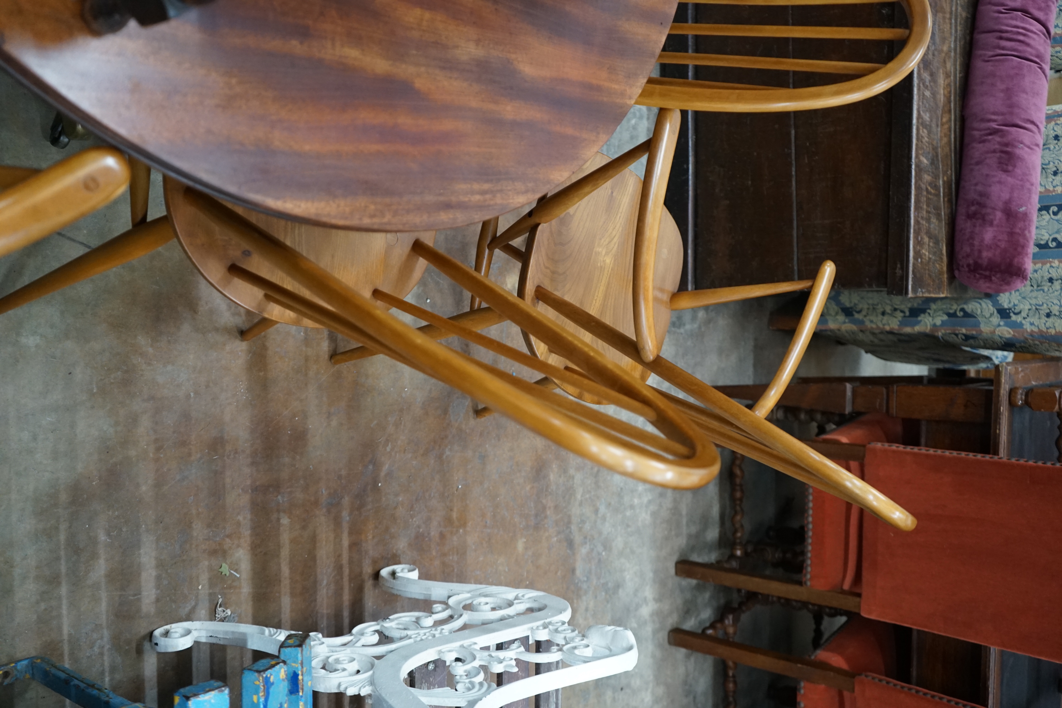 A set of six Ercol elm and beech comb back dining chairs, two with arms